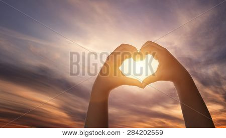 Close Up Of Child Hands Formig Heart Shape Over Beautiful Sky Background With Copy Space