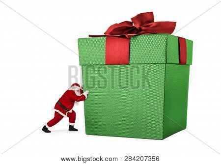 Close Up Of Santa Claus Pushing Huge Bag Of Presents Isiolated On White Background