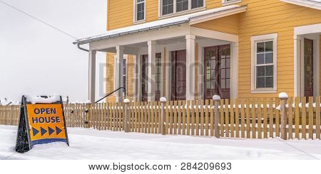 Home And Open House Sign Against Snow In Winter