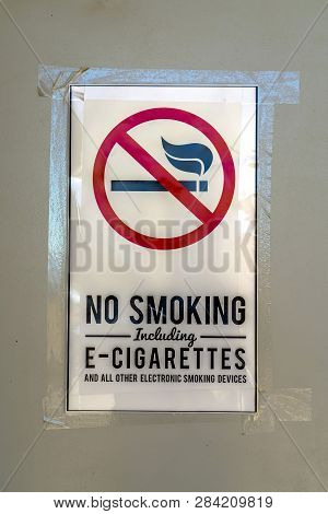 No Smoking Sign Taped On A Gray Surface