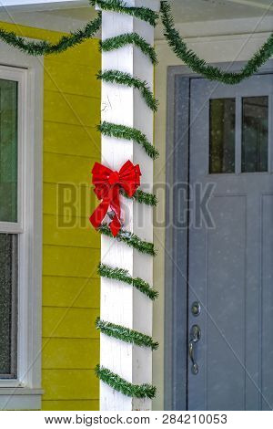 Pillar With Ribbon And Wrapped In String Of Leaves