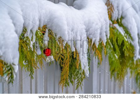 Snowy Garland Lining A Fence During Winter In Utah