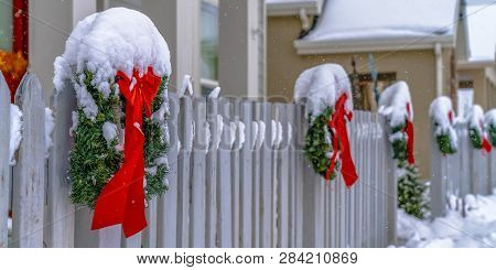 Snowy Wreaths On Picket Fence In Daybreak Utah