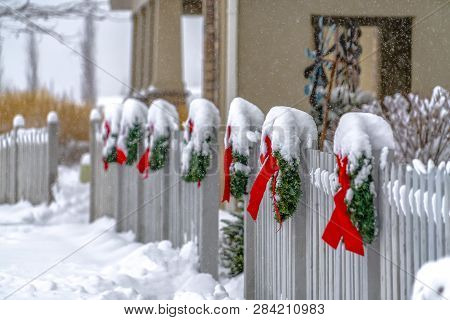 White Picket Fence With Wreaths In Daybreak Utah