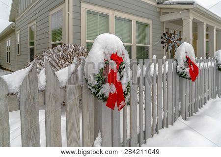 Winter Landscape With Wreath On A Picket Fence