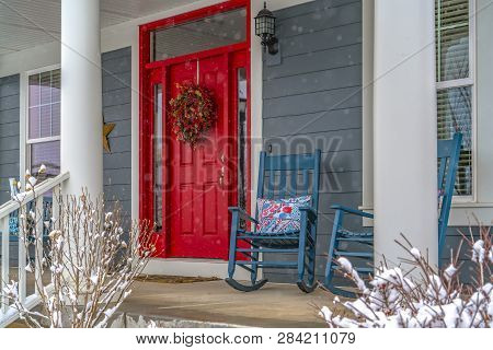 Winter View Of Home With Red Door And Front Porch