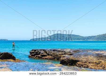 People Enjoying The Sunny Weather At Pebbly Beach, A Popular Camping Area With Great Surfing Beach A