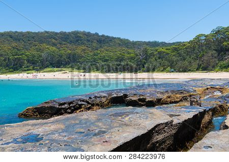People Enjoying The Sunny Weather At Pebbly Beach, A Popular Camping Area With Great Surfing Beach A