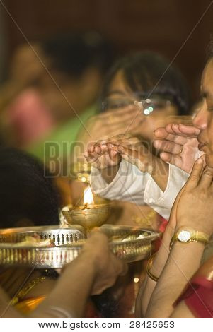 Hindu Devotees Put Their Hands Over A Flame During The Chariot Festival At Richmomd Hill Temple