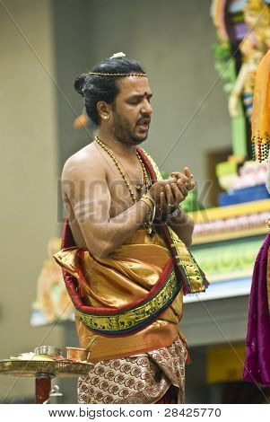 Hindu Priest Performs The Pooja For The Hindu Devotees During The Chariot Festival At Richmomd Hill