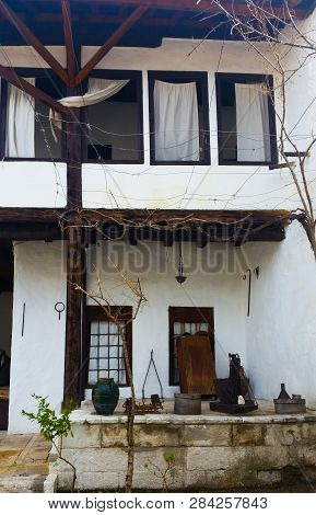 An Old Folk House With Lovely White Curtains With Old Cultures