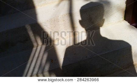 A Man With A Shadow On Sunday Light