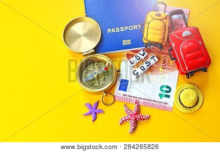 Low Cost Travel Concept Background With Biometric Passport Id, Euro, Compass, Miniature Baggage And 