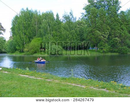 Peaple Sailing In Old Boat On River