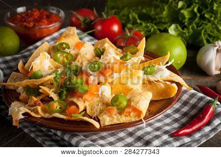 Mexican Nachos With Tortilla, Hot Pepper, Melted Cheese, Ketchup And White Sauce, Jalapeno And Lime 