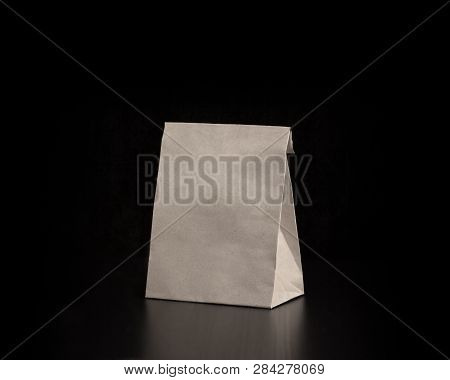 Blank Craft Paper Bag On Wooden Background. Responsive Design Mockup.