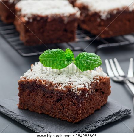 Homemade Brownie With Coconut Flakes, Swedish Dessert Karleksmums, Cut In Square Servings, On Stone 