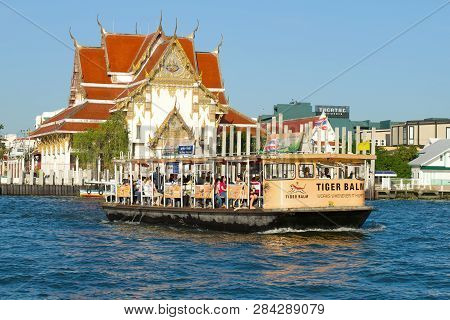Bangkok, Thailand - January 01, 2019: River Ferry Against The Backdrop Of A Buddhist Temple Wat Rakh