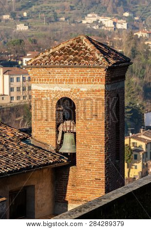 Ancient Bell Tower Made Of Bricks In The Small Town Of Barga, Lucca Province, Tuscany, Italy, Europe