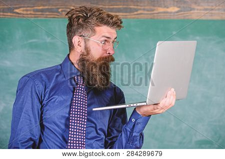 Hipster Teacher Wear Eyeglasses And Necktie Holds Laptop Surfing Internet. Shocking News. Teacher Be