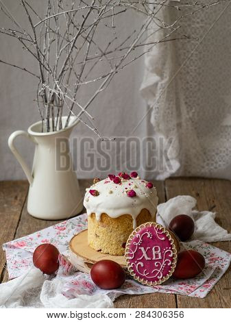 Easter Cake Kulich. Traditional Easter Sweet Bread Decorated Meringue, Pink Dry Roses, Red Eggs And 