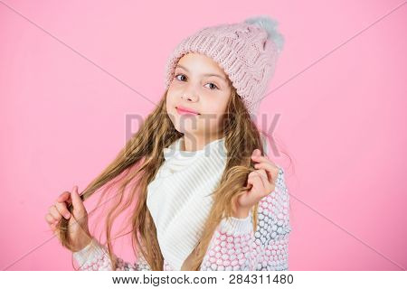Child Long Hair Smiling. Girl Wear Knitted Hat Pink Background. Prevent Winter Hair Damage. Winter H