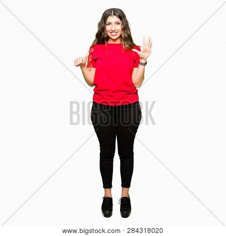 Young beautiful woman wearing casual t-shirt showing and pointing up with fingers number six while smiling confident and happy.