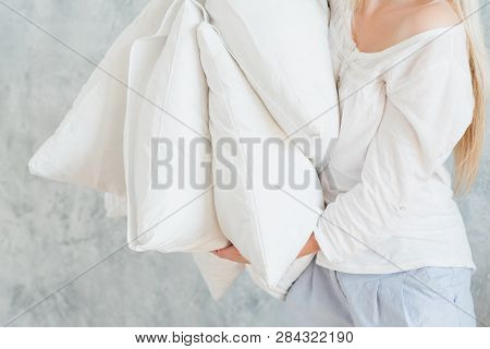 Quality Bedding. Sound Sleep Concept. Woman Holding Pile Of Pillows.