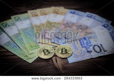 Cryptocurrency, Bitcoins, Paper Of The Belarusian Ruble. Metal Coins Are Laid Out On A Flat Backgrou