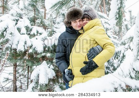 Russia, Ryazan 04 Jan 2017: Husband Hugs And Walking With Pregnant Wife In Frozen Winter Forest