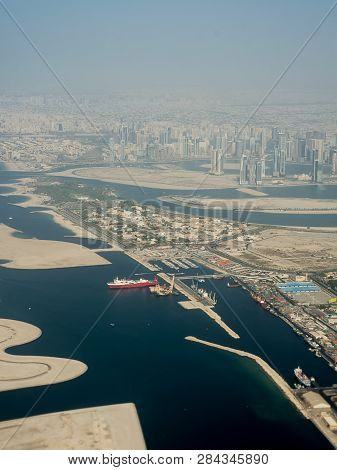 Dubai's Buildings And Harbor Seen From The Airplane Taking Off