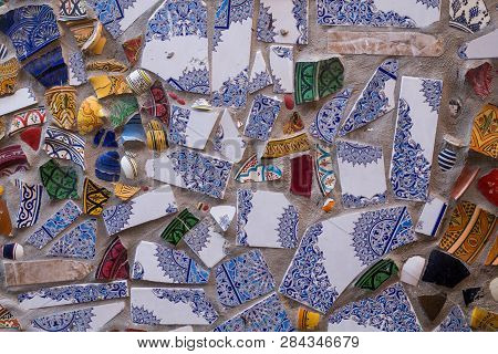 Colorful Shards Of Ornamental Floral Traditional Ceramic, Reused After Breaking For A Wall Outdoors.