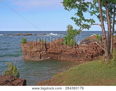 Sandstone Cliffs Line The Shore Of Lake Superior At Presque Isle Park At Marquette In The Upper Peni