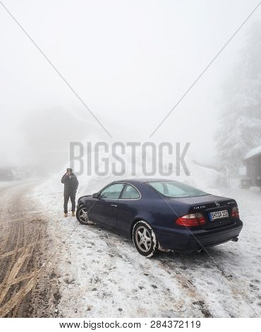 Mummelsee, Germany - Jan 26, 2018: Man Calling On Mobile Phone Near His Mercedes-benz Clk 230 Kompre
