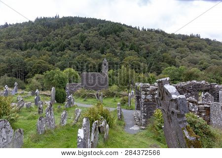 Ancient Celtic Gravesite With Unmarked Gravestones And Old Rundown Church In Ireland