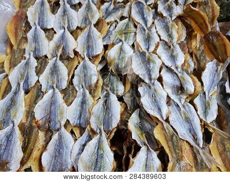 Top View Of Dried Salted Fish For Cooking, For Sale In The Fish Market, As A Background (yellow-stri