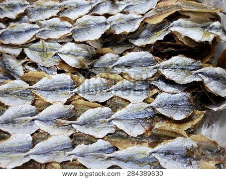 Top View Of Dried Salted Fish For Cooking, For Sale In The Fish Market, As A Background (yellow-stri