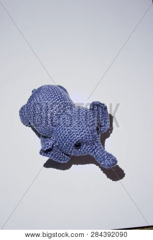 Little Grey Elephant Crocheted Sitting On White Background Top View