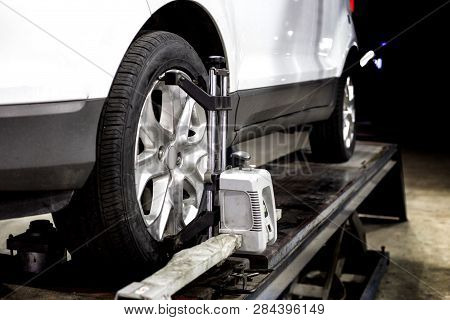 Wheel Aligment Service On Garage With Robot Technology In Automotive Car Repairing