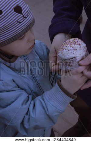 Rostov-on-don, Russia, 04/08/2018, Easter. A Boy In A Blue Jacket And A Striped Hat Holding A Cake T