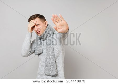 Abhorred Young Man In Gray Sweater, Scarf Putting Hand On Forehead, Showing Stop Gesture With Palm I