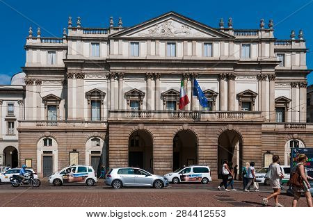 Milan, Italy. July 7, 2015. Busy Traffic And Pedestrians Liven Up The Streets Of Cental Milan,  Near