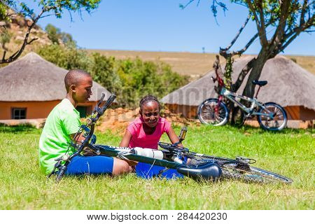 African Children Fixing A Puncture On A Bike