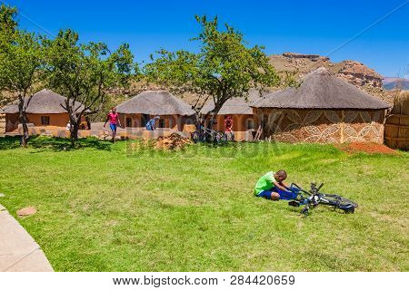 African Children Fixing A Puncture On A Bike