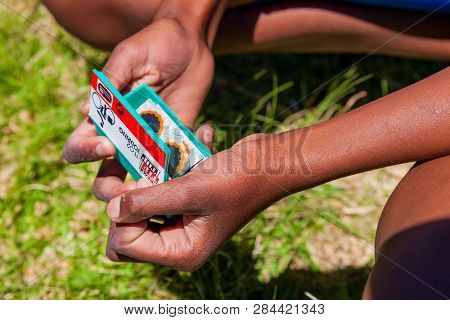 African Children Fixing A Puncture On A Bike