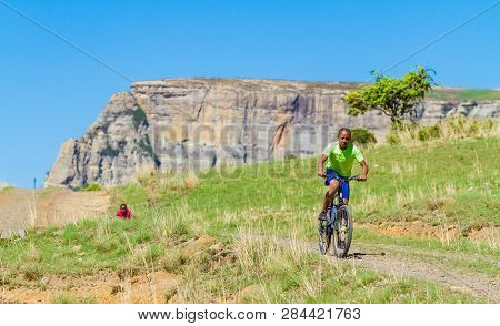 African Children Riding A Bike In Rural A Village