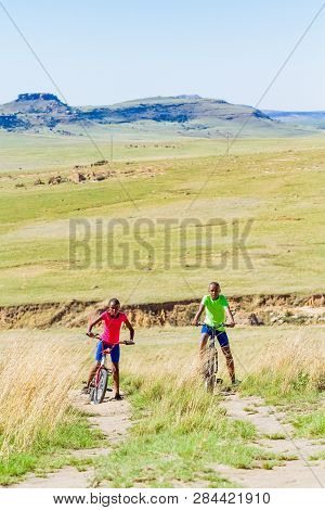 African Children Riding A Bike In Rural A Village
