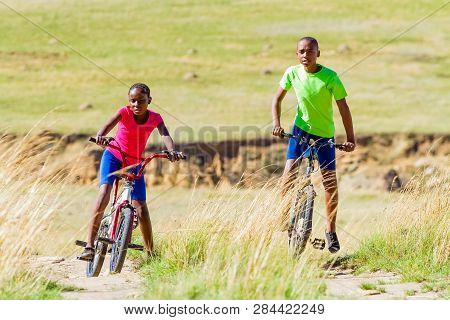 African Children Riding A Bike In Rural A Village