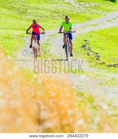 African Children Riding A Bike In Rural A Village