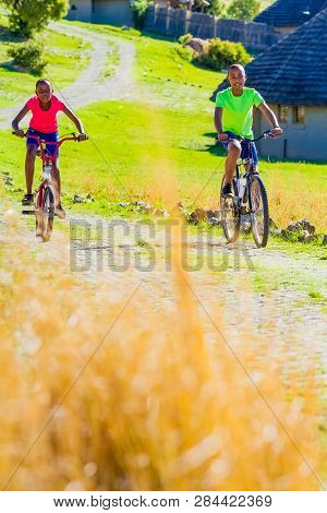 African Children Riding A Bike In Rural A Village